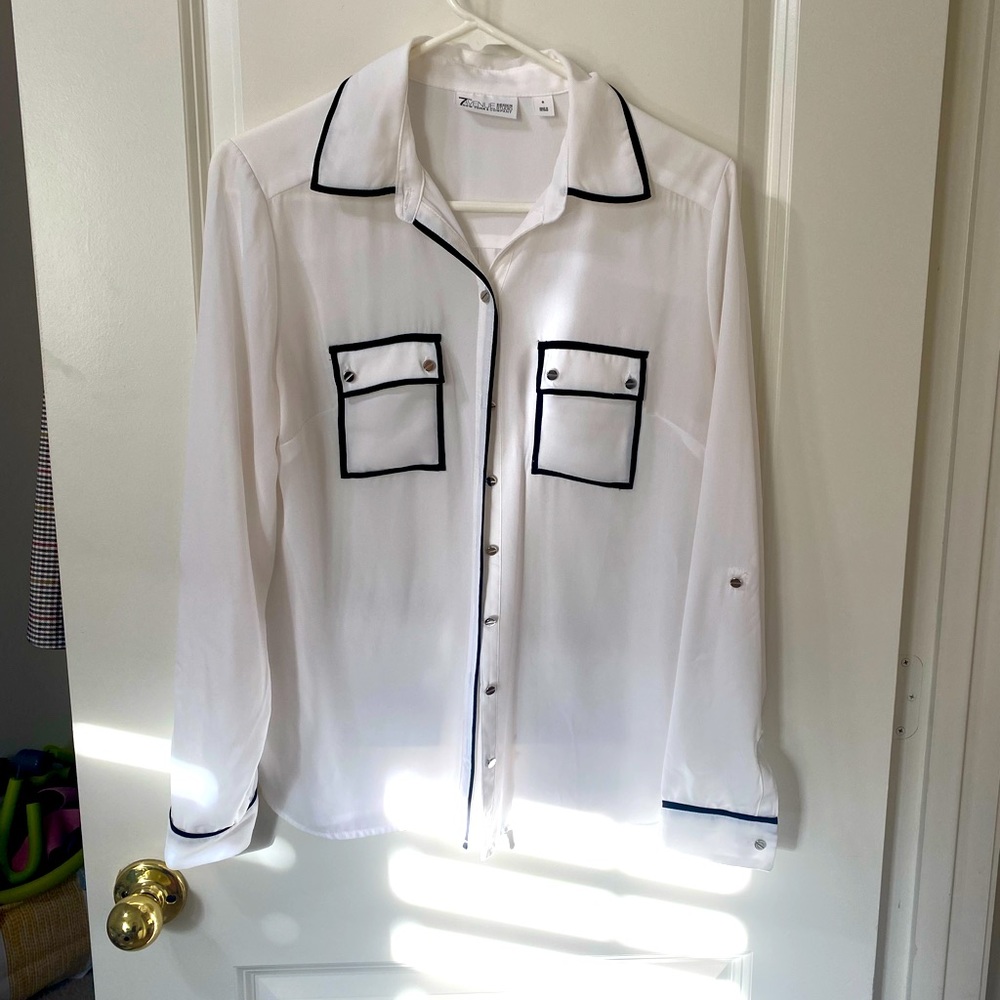 White sheer blouse with black trim pockets, sleeves & collar.